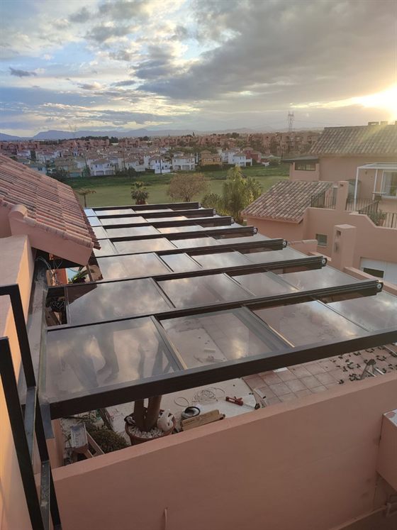 Glasdach auf einer Terrasse bei Sonnenuntergang